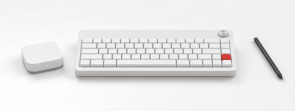 White keyboard, compute module, and black stylus arranged as the Agent Keyboard system